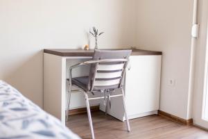 a chair sitting at a desk in a bedroom at Apartmani Mia in Prozor