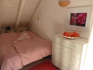 a bedroom with a bed and a bowl on a dresser at Bed and Breakfast Bavaria München in Icking