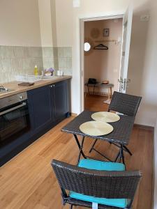 a kitchen with a table and two chairs and a counter at Cozy Apartment Old Town in Constanţa