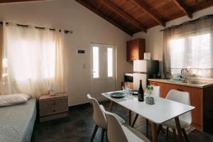 a kitchen with a table and chairs in a room at Elenis Spiti in Moírai