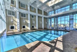 a large swimming pool in a building with windows at Majestic Sun 1012A in Destin
