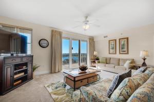a living room with a couch and a tv at Ariel Dunes II 801 in Destin