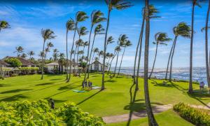 a park with palm trees and the ocean at Kiahuna Plantation Unit 118 - 2nd Floor Expansive Views, Air Conditioning in Koloa