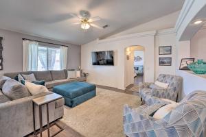 a living room with couches and a ceiling fan at Lake Havasu Home with EV Charger Near Launch Ramp! in Lake Havasu City