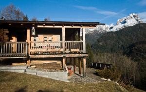 a log cabin with a view of a mountain at Chalet Bait del Papi in Madonna di Campiglio