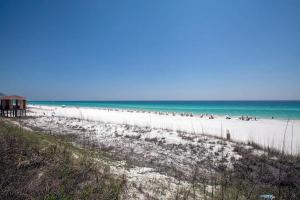 a beach with a lot of people and the ocean at Seabreeze Escape in Destin