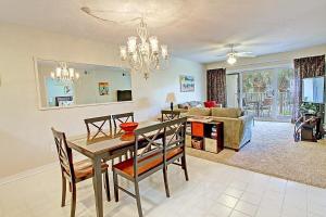 a dining room and living room with a table and chairs at Maravilla 3202 in Destin