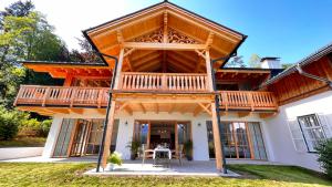 a large timber house with a large deck at Villa Frischmuth am See in Altaussee