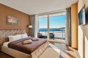 a bedroom with a bed with a view of the ocean at Марістелла Морська Перлина in Odesa