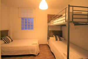アリカンテにあるCasaTuris Plaza Nueva en el centro de Alicante A110のベッドルーム1室(二段ベッド2台、窓付)が備わります。