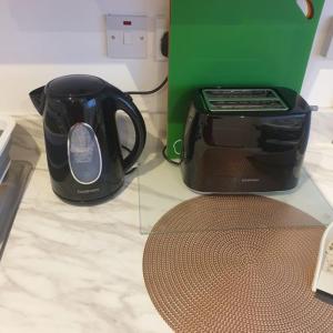 a black toaster sitting on a counter next to a toaster at Swilly View Lodge in Linsfort