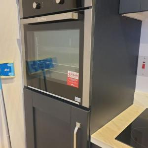 a kitchen with a oven with a sign on it at Swilly View Lodge in Linsfort