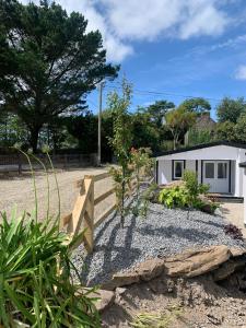 a garden with a fence and a house at Milltown House Dingle in Dingle