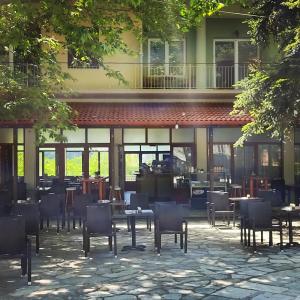 a restaurant with tables and chairs in front of a building at FANTINO HOTEL in Domnista