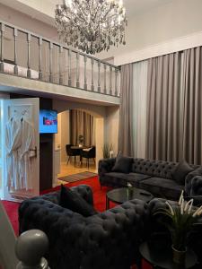 a living room with couches and a chandelier at La Bourse Hotel in Brussels