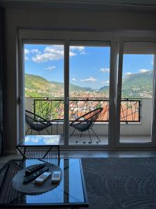 a living room with a view of a balcony at Villa Mahala in Sarajevo