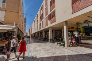 a group of people walking down a street at Petit Palace in Zadar