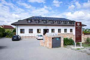 a building with a parking lot in front of it at Amenity Penzion Horni Vestonice in Horní Věstonice