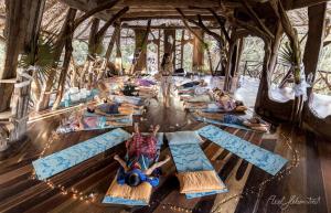 a group of people laying on the floor doing yoga at Akalki Hotel y Centro Holistico in Bacalar