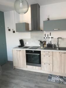 a kitchen with a sink and a stove top oven at Lou Maset 2 in Saint-Paul-Trois-Châteaux