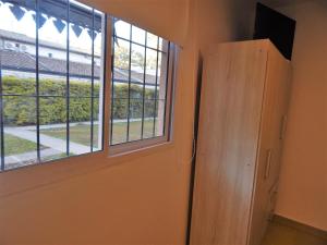 a room with a door and a window at Departamentos Emilia in Yerba Buena