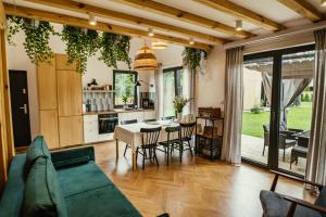 a living room with a couch and a table with chairs at Domki Jodełka in Krasnobród