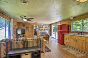 a kitchen and living room with a red refrigerator at Cozy Florence Cabin, Proximity to Keyes Peak! in Florence