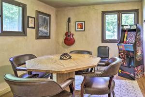 a room with a table and chairs and a guitar at Cozy Florence Cabin, Proximity to Keyes Peak! in Florence