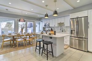 a kitchen with a large island with bar stools at Philly Townhome with Private Patio and City Views in Philadelphia