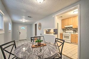 a kitchen and dining room with a table and chairs at Convenient Pensacola Home with Deck and Fire Pit! in Pensacola