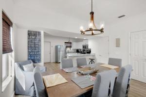 a dining room and kitchen with a table and chairs at Palm Grove at Sago Sands Unit A in Seagrove Beach
