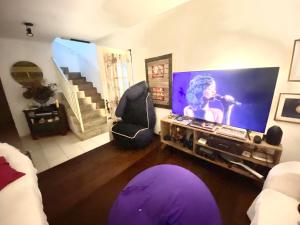 a living room with a large flat screen tv at Pousada Family Consulado Americano in São Paulo
