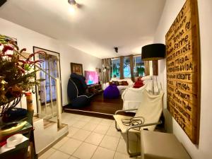 a living room with white furniture and a tv at Pousada Family Consulado Americano in São Paulo