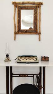 a desk with a keyboard and a mirror on it at Laina Traditional Guest House in Apeiranthos