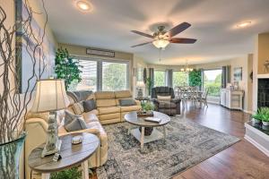 a living room with a couch and a ceiling fan at Beautiful Hot Springs Condo with Lake Hamilton Views in Hot Springs