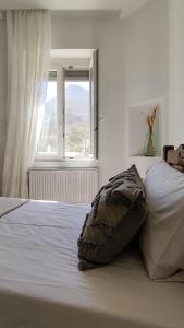 a bed in a bedroom with a large window at Laina Traditional Guest House in Apeiranthos