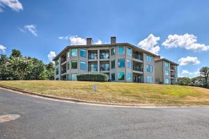 a large building on top of a grassy hill at Beautiful Hot Springs Condo with Lake Hamilton Views in Hot Springs