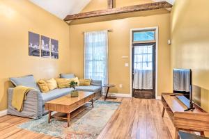 a living room with a couch and a tv at Charming 1875 Indianapolis Home in Downtown! in Indianapolis
