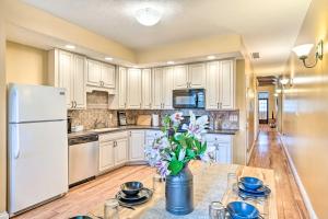 a kitchen with white cabinets and a white refrigerator at Charming 1875 Indianapolis Home in Downtown! in Indianapolis