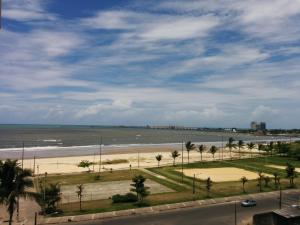 a view of a beach with palm trees and the ocean at Rede Andrade Barravento in Ilhéus