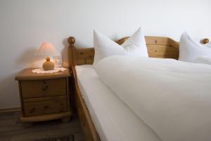 クックスハーフェンにあるFrische-Brise-06-01のベッドルーム1室(白いシーツとランプ付きのベッド2台付)