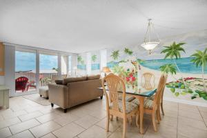 a living room with a table and a couch at Dolphin Point #406C in Destin