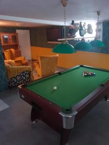 a living room with a pool table in a room at Domek Góralski Limba 1 in Kościelisko