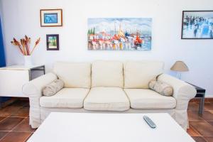 a white living room with a white couch at Eslanzarote La Duna House, Wifi, Sea views in Caleta de Sebo