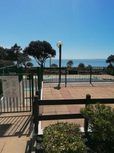 a fence in front of a beach with the ocean at Appartement Pornic vue mer in Pornic