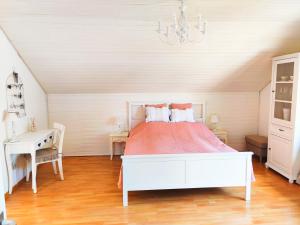 a bedroom with a bed and a table and a chandelier at Romantic Style Apartment Titisee in Titisee-Neustadt