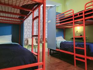 a bunk bed room with two beds and two bunk beds at Orange Village Hostel in San Francisco +199 photos