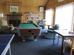 a living room with a pool table and chairs at Eastwood at Provincetown in Provincetown