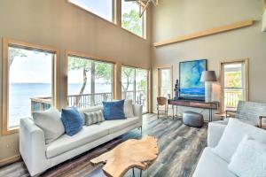 a living room with a couch and a table at Family-Friendly Home on Pelican Lake with Fire Pit in Dunvilla