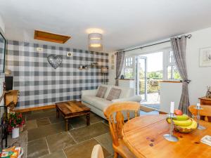 a living room with a couch and a table at Ivy Cottage in Ripon +14 photos